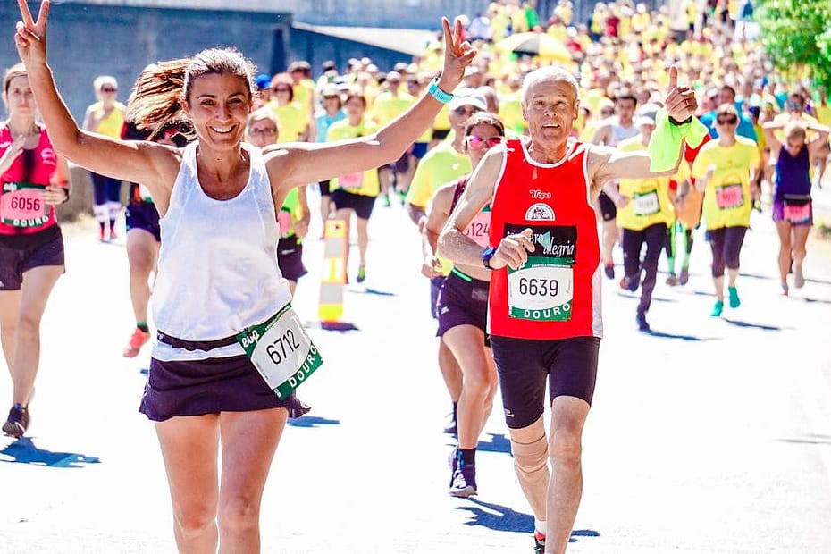 A group of diverse runners participating in a lively marathon event under the sun.