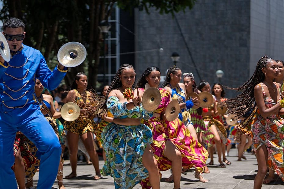Colorful dancers and musicians celebrate in the streets of San José, Costa Rica, embodying cultural joy.